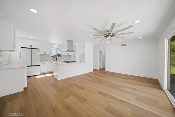 a kitchen with stainless steel appliances granite countertop a sink a stove and cabinets