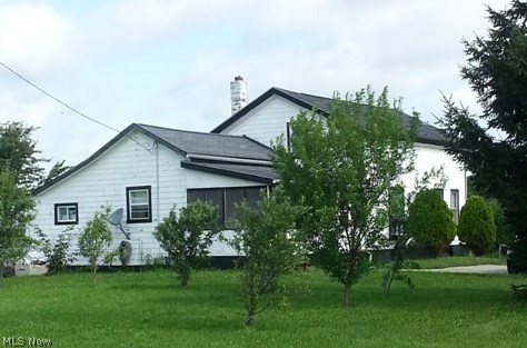 4310 Bryenton Road Litchfield, OH 44253 - Photo 1 of 18 Front and side view from the southwest showing the many young fruit trees and screened in attached porch. Could be a 3 or 4 season room.