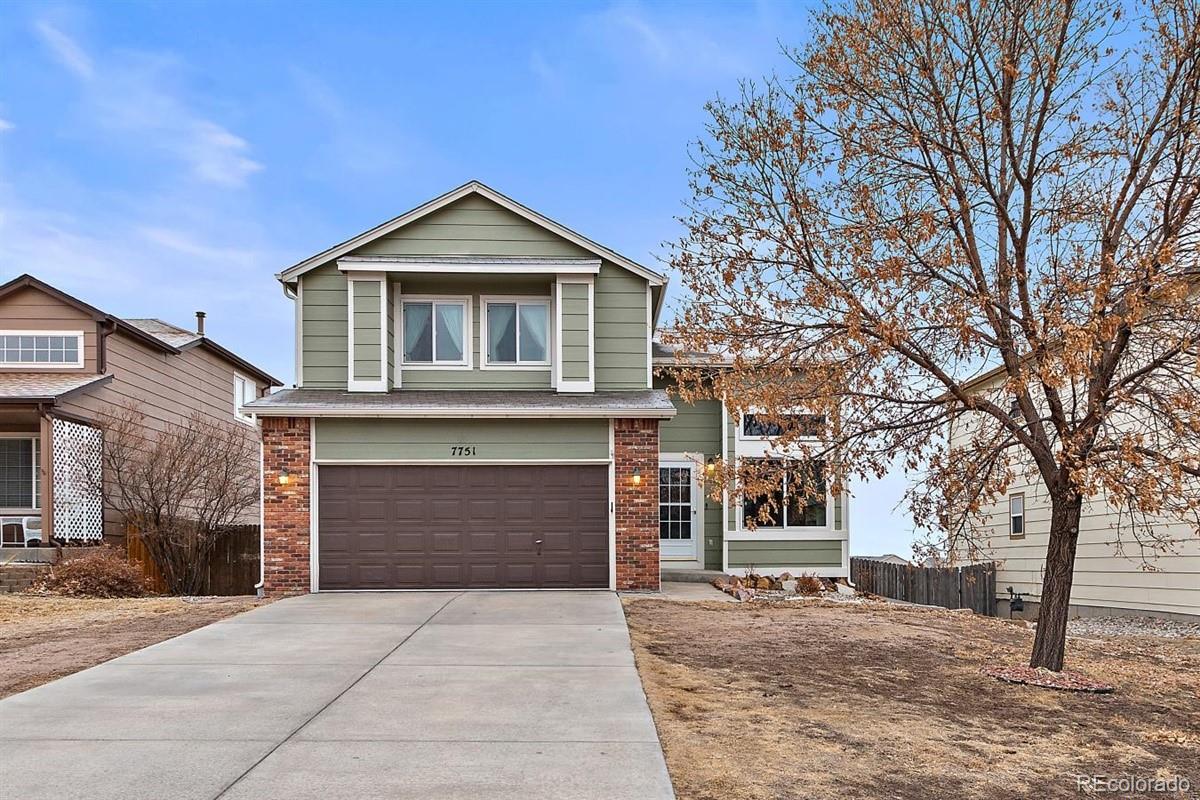 7751 Old Spec Road Peyton, CO 80831 - Photo 1 of 17 a front view of a house with yard