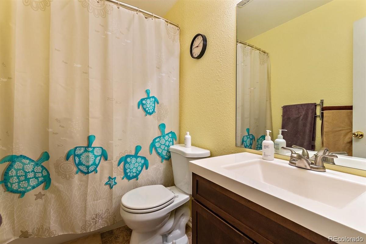 7751 Old Spec Road Peyton, CO 80831 - Photo 12 of 17 a bathroom with a sink toilet and shower