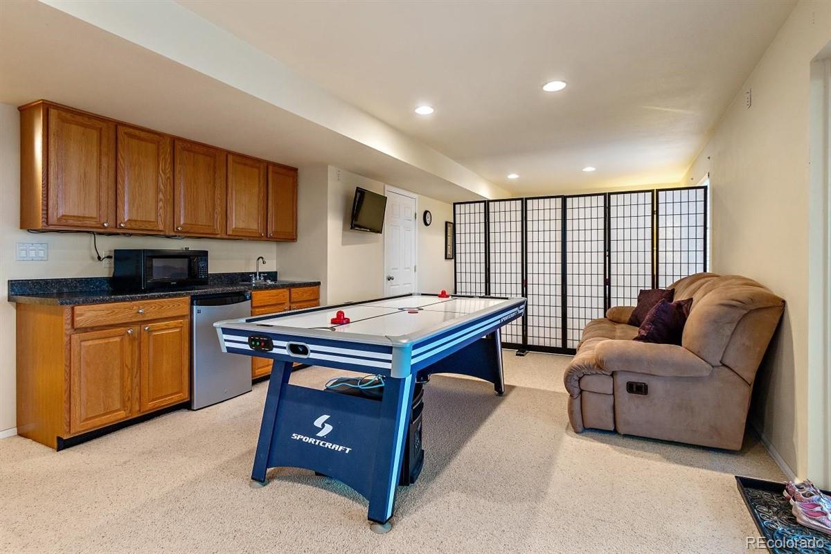 7751 Old Spec Road Peyton, CO 80831 - Photo 14 of 17 a living room with furniture a large window with kitchen view