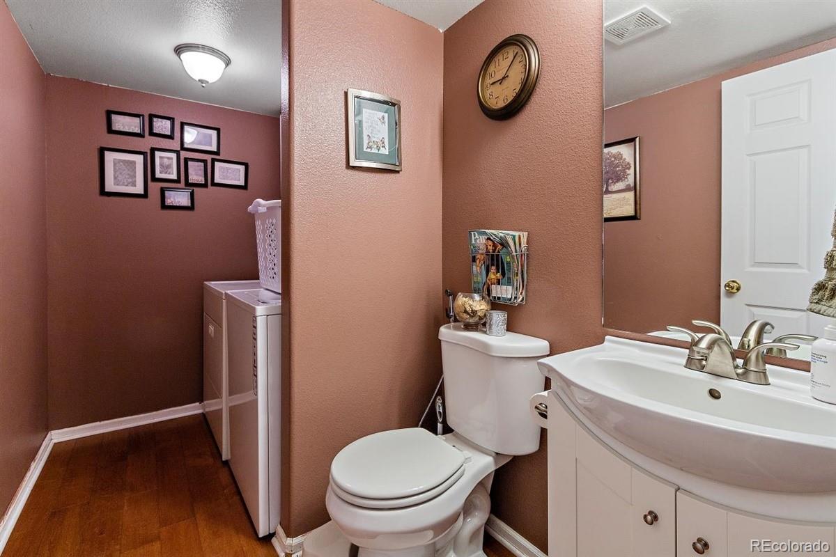 7751 Old Spec Road Peyton, CO 80831 - Photo 5 of 17 a bathroom with a toilet a sink and a mirror