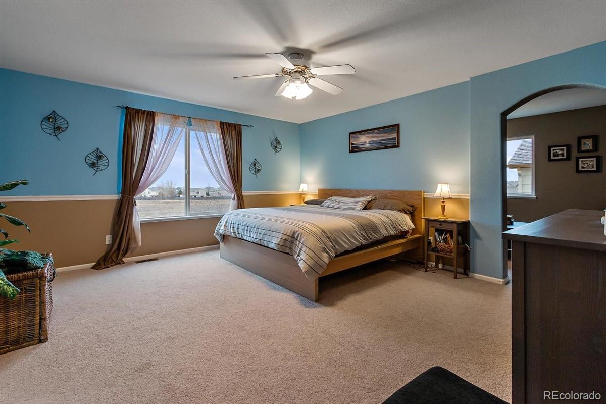 7751 Old Spec Road Peyton, CO 80831 - Photo 6 of 17 a bed room with a bed and a ceiling fan