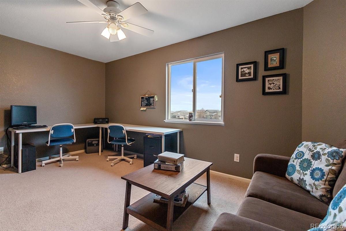 7751 Old Spec Road Peyton, CO 80831 - Photo 7 of 17 a livingroom with workspace and a couch