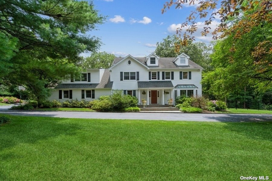 48 Timber Ridge Drive Laurel Hollow, NY 11771 - Photo 1 of 1 a front view of a house with a yard
