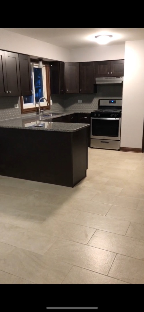 10301 McVicker Avenue Chicago Ridge, IL 60415 - Photo 12 of 21 a kitchen with kitchen island a sink