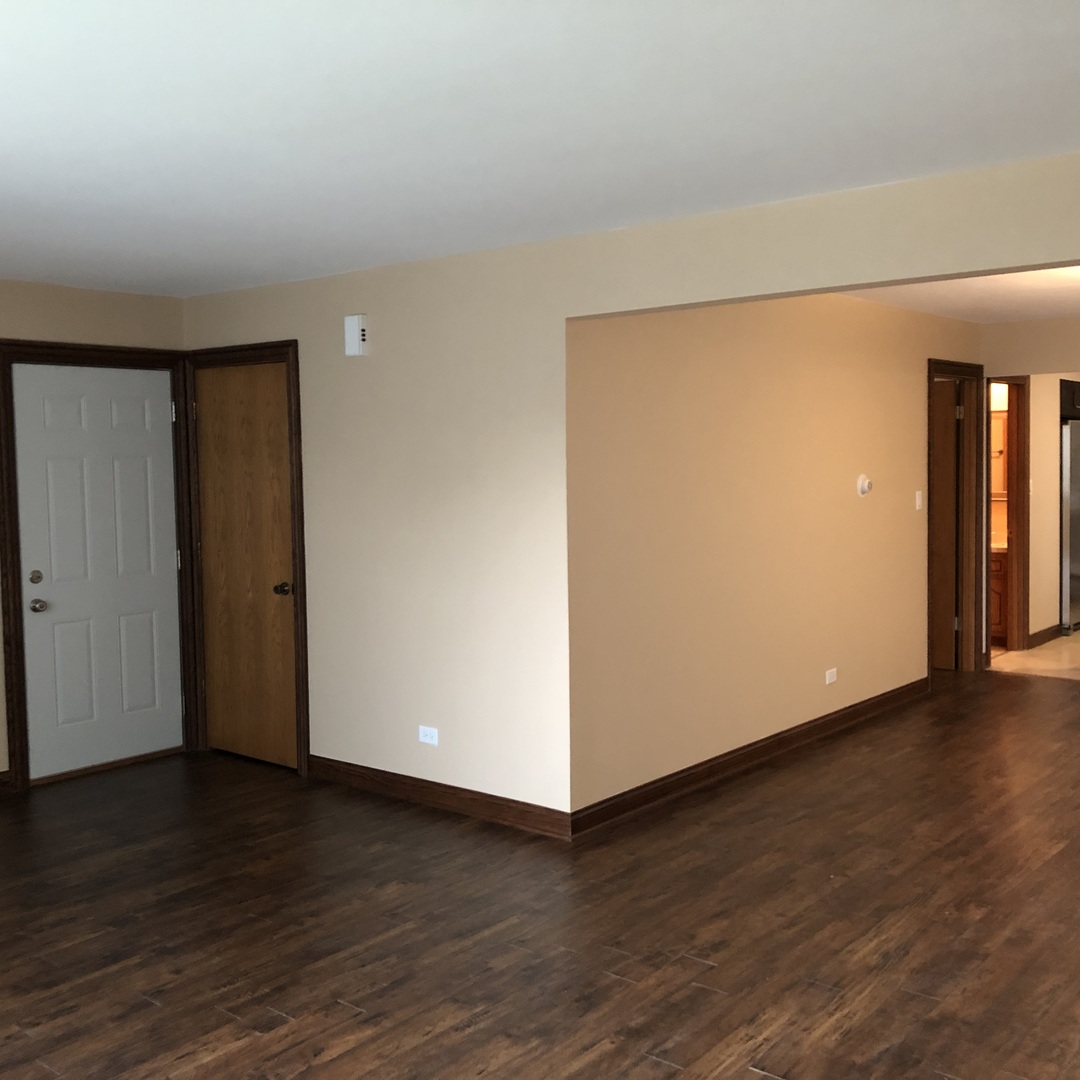 10301 McVicker Avenue Chicago Ridge, IL 60415 - Photo 13 of 21 a view of an empty room with wooden floor and closet