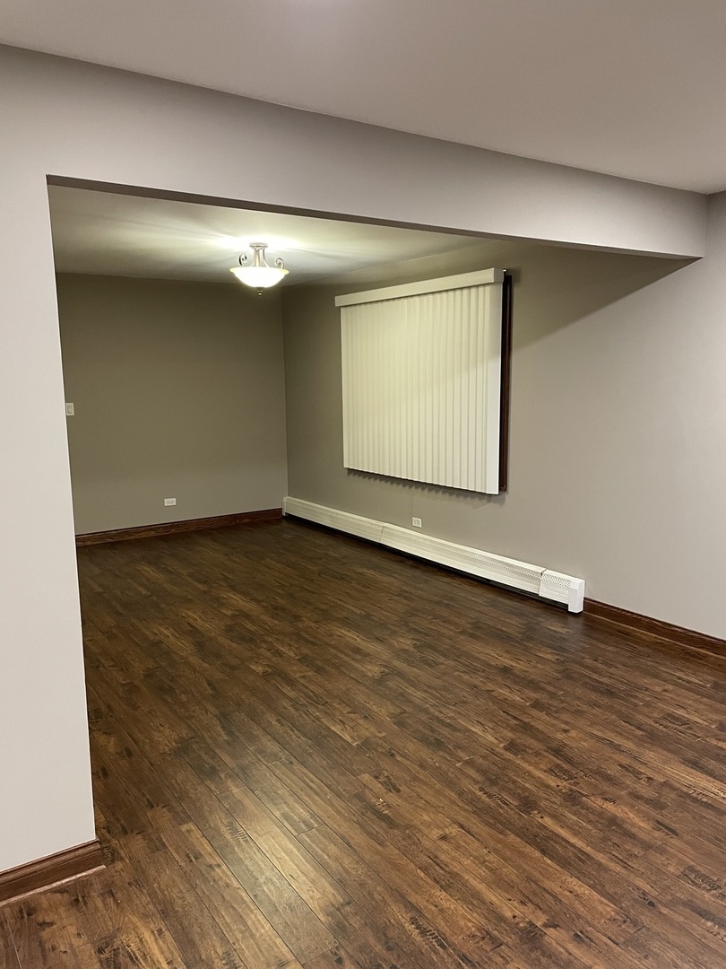 10301 McVicker Avenue Chicago Ridge, IL 60415 - Photo 17 of 21 an empty room with wooden floor and windows
