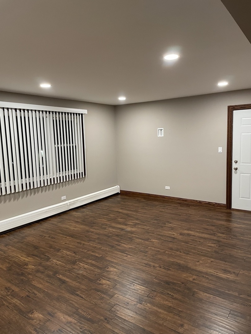10301 McVicker Avenue Chicago Ridge, IL 60415 - Photo 18 of 21 an empty room with wooden floor and windows