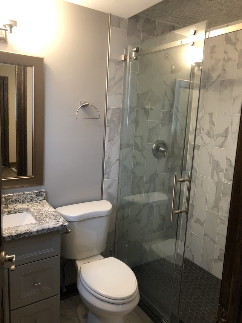 10301 McVicker Avenue Chicago Ridge, IL 60415 - Photo 7 of 21 a bathroom with a toilet and a shower