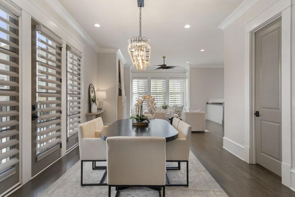 3715 Peachtree Road Northeast, Unit 12 Atlanta, GA 30319 - Photo 14 of 62 a dining room with wooden floor a chandelier a glass table and chairs