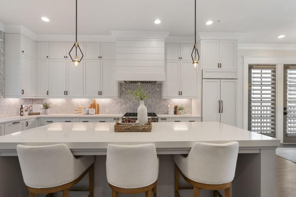 3715 Peachtree Road Northeast, Unit 12 Atlanta, GA 30319 - Photo 20 of 62 a kitchen with stainless steel appliances granite countertop a dining table chairs sink and white cabinets