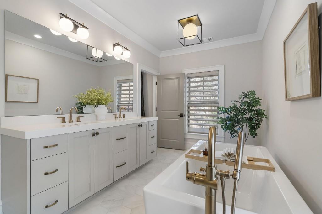 3715 Peachtree Road Northeast, Unit 12 Atlanta, GA 30319 - Photo 32 of 62 a bathroom with a sink a potted plant and a mirror