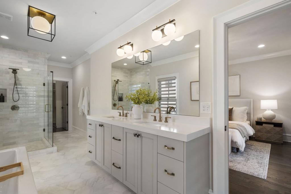 3715 Peachtree Road Northeast, Unit 12 Atlanta, GA 30319 - Photo 34 of 62 a bathroom with a double vanity sink mirror and shower