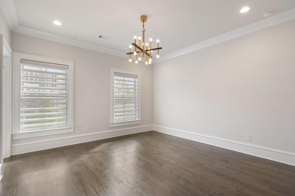 3715 Peachtree Road Northeast, Unit 12 Atlanta, GA 30319 - Photo 37 of 62 an empty room with wooden floor chandelier fan and windows