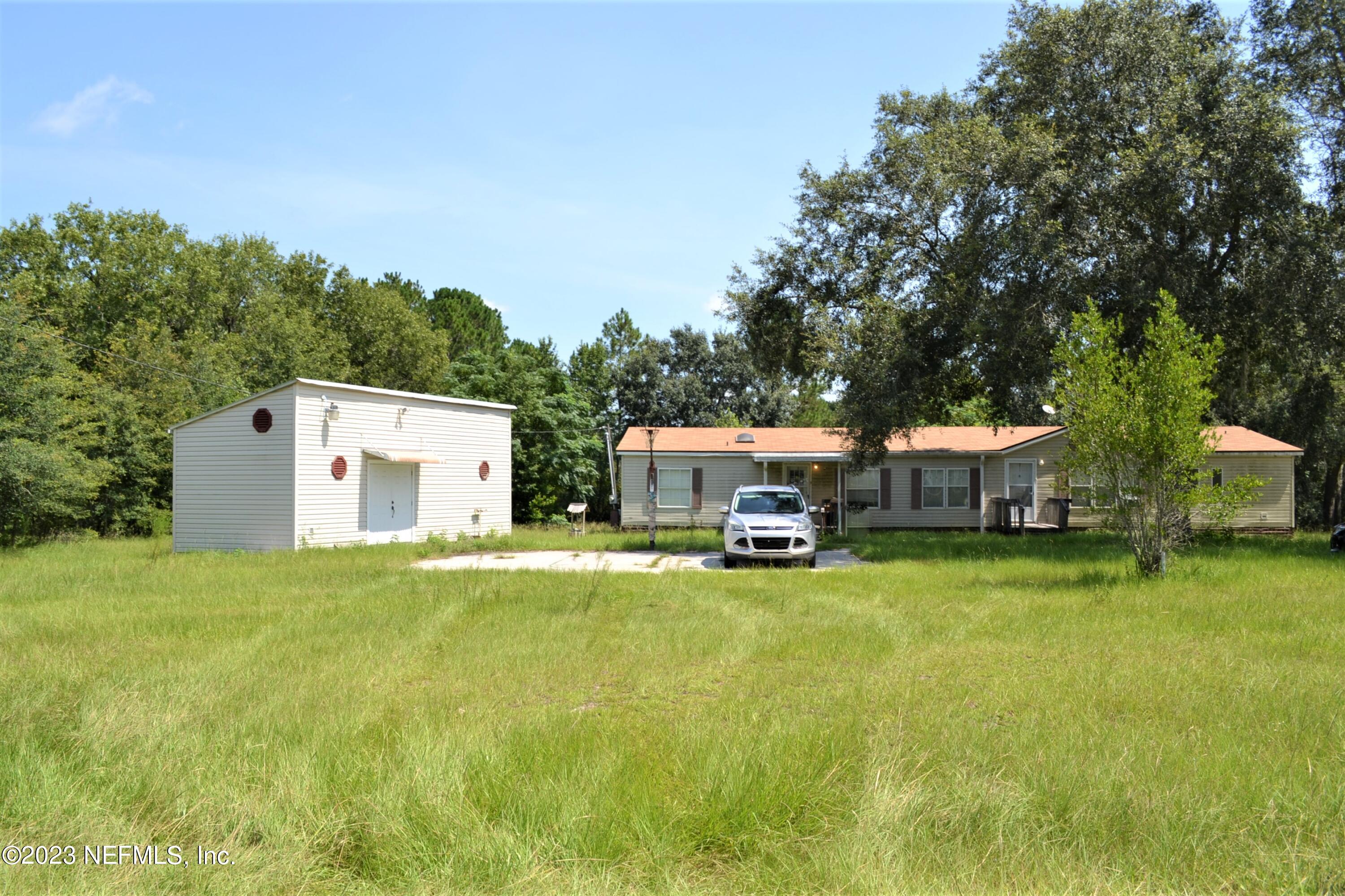 4520 Racoon Run Middleburg, FL 32068 - Photo 1 of 26 a house view with a sitting space and garden