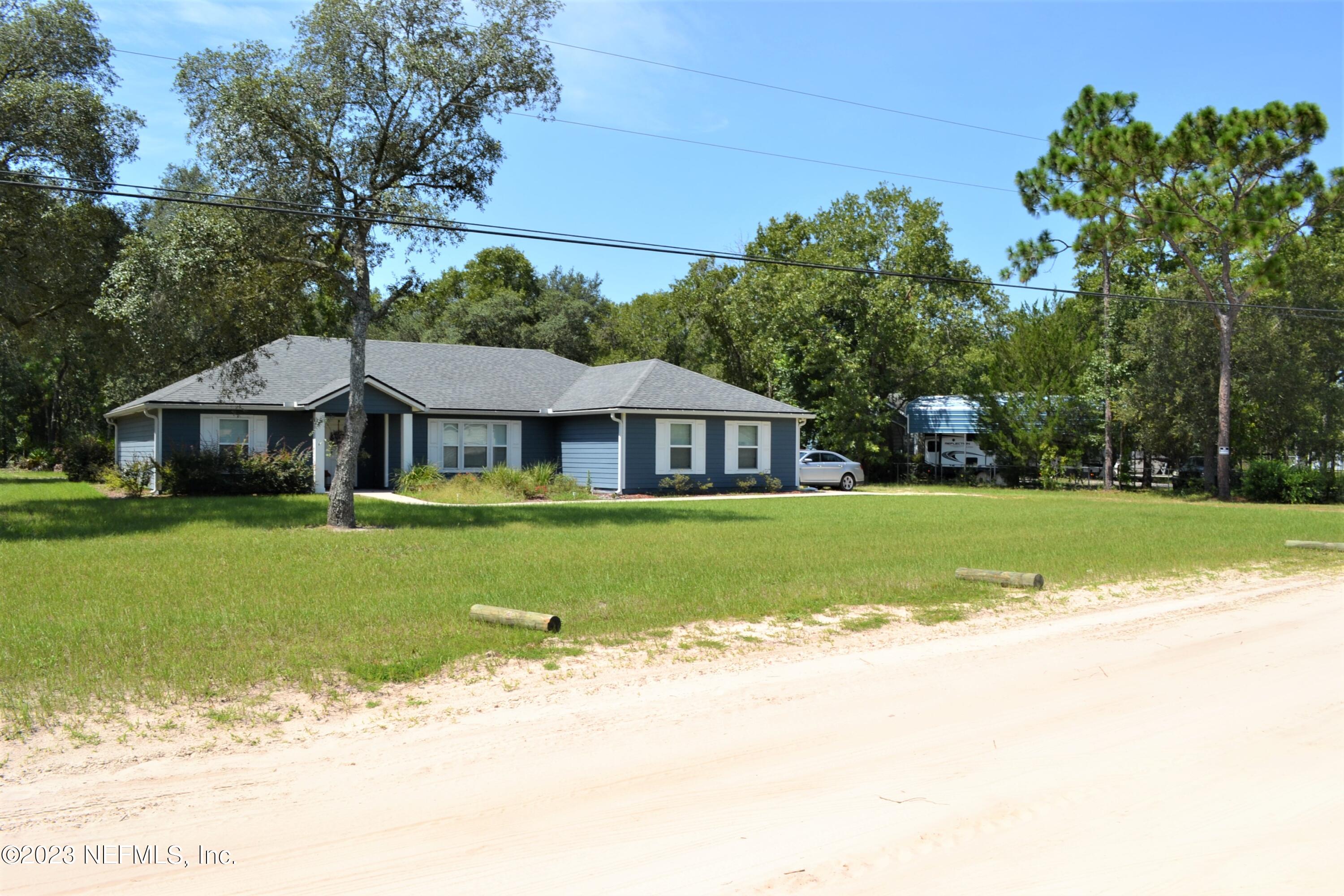 4520 Racoon Run Middleburg, FL 32068 - Photo 13 of 26 a front view of a house with garden