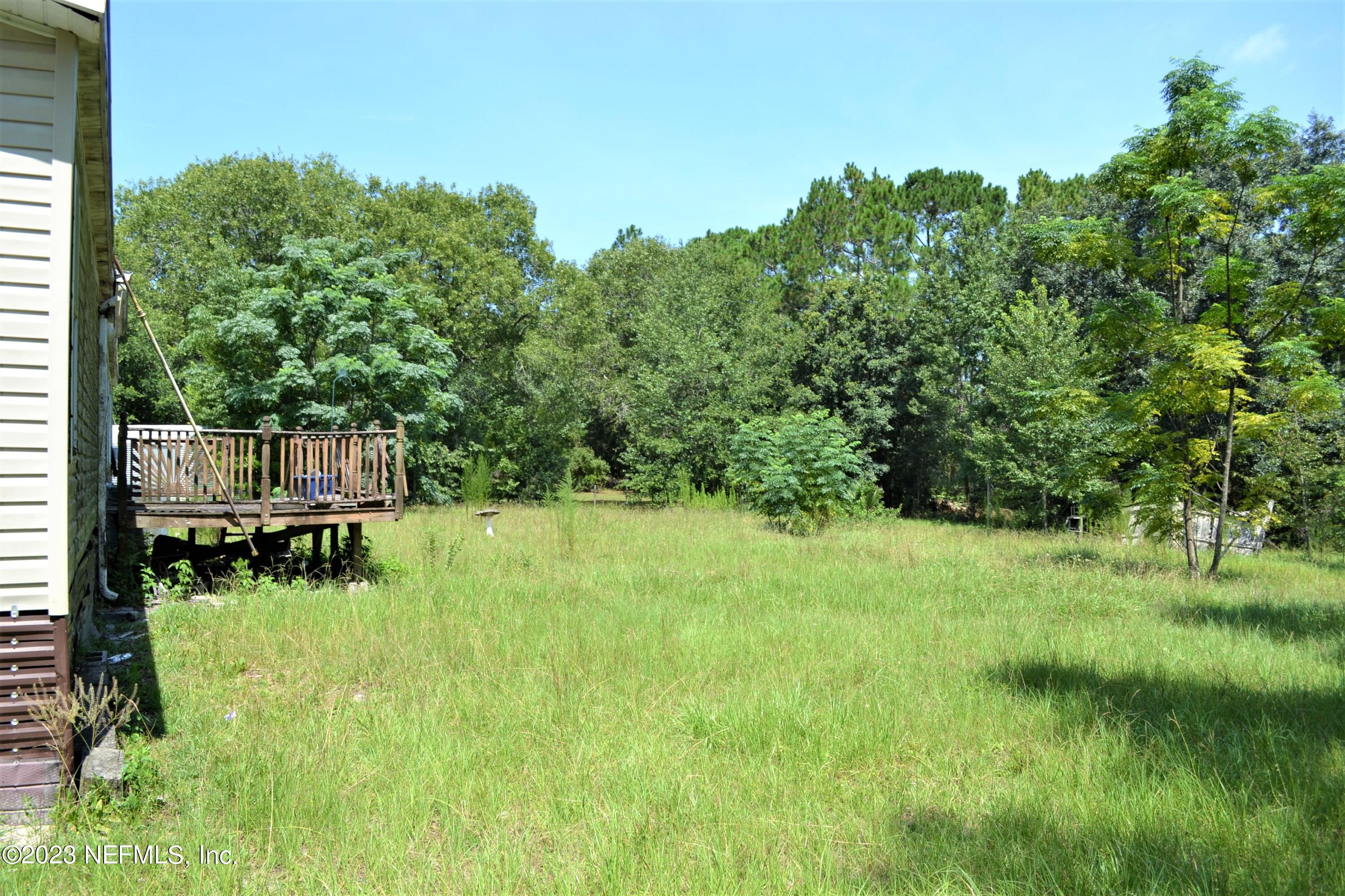 4520 Racoon Run Middleburg, FL 32068 - Photo 17 of 26 a backyard of a house with a yard and outdoor seating