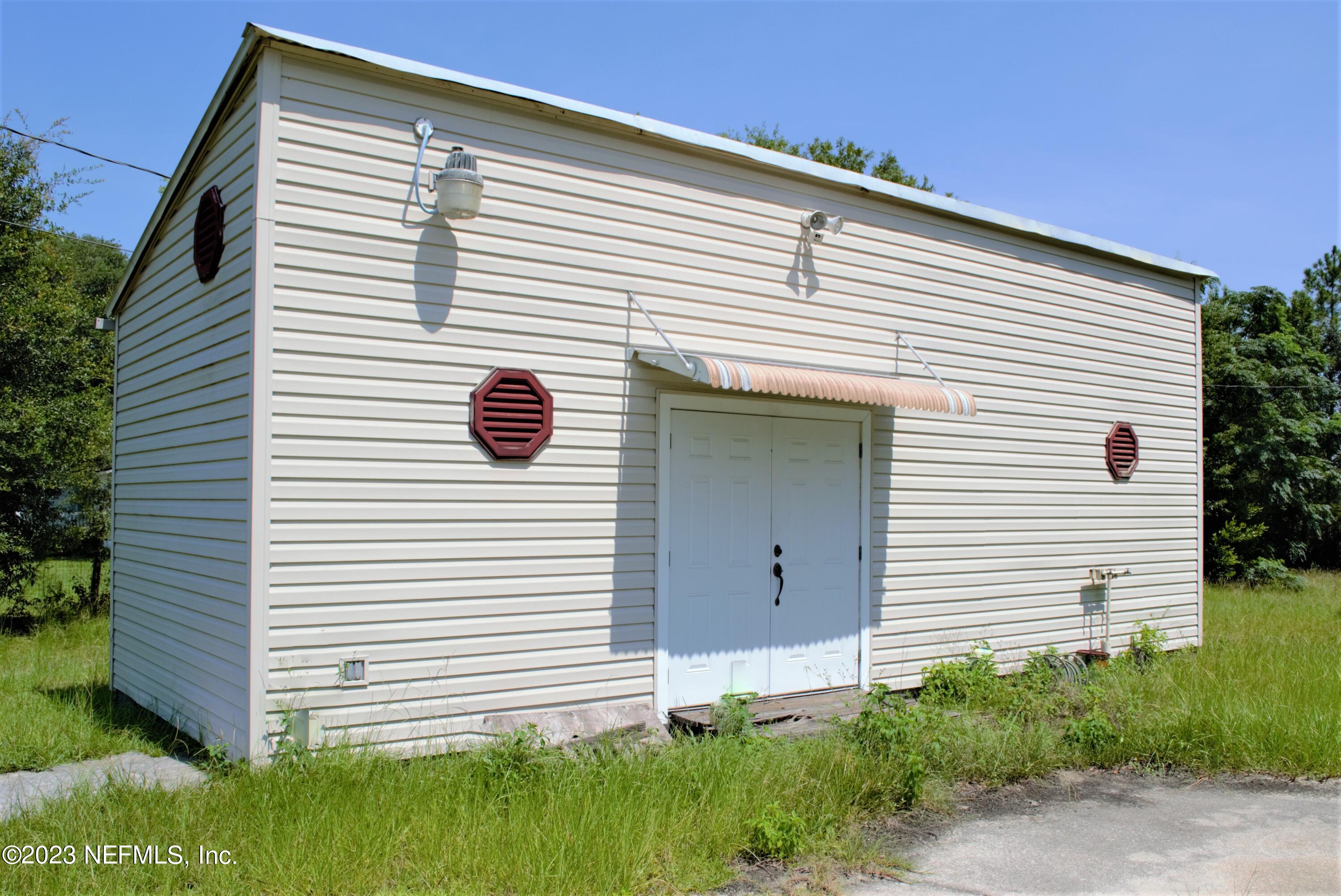 4520 Racoon Run Middleburg, FL 32068 - Photo 2 of 26 a view of a white house with a yard and plants