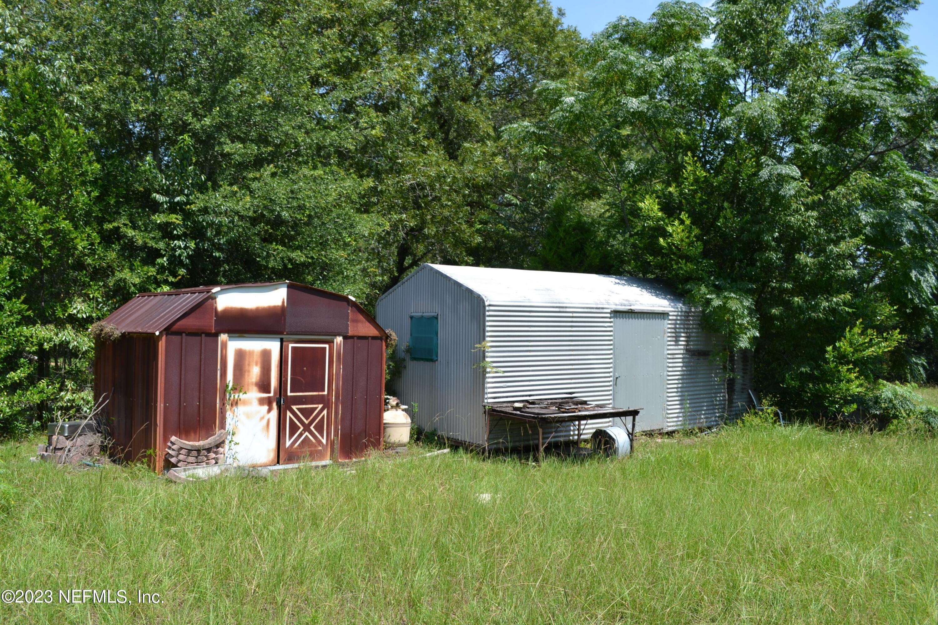 4520 Racoon Run Middleburg, FL 32068 - Photo 24 of 26 a front view of a house with a yard and trees