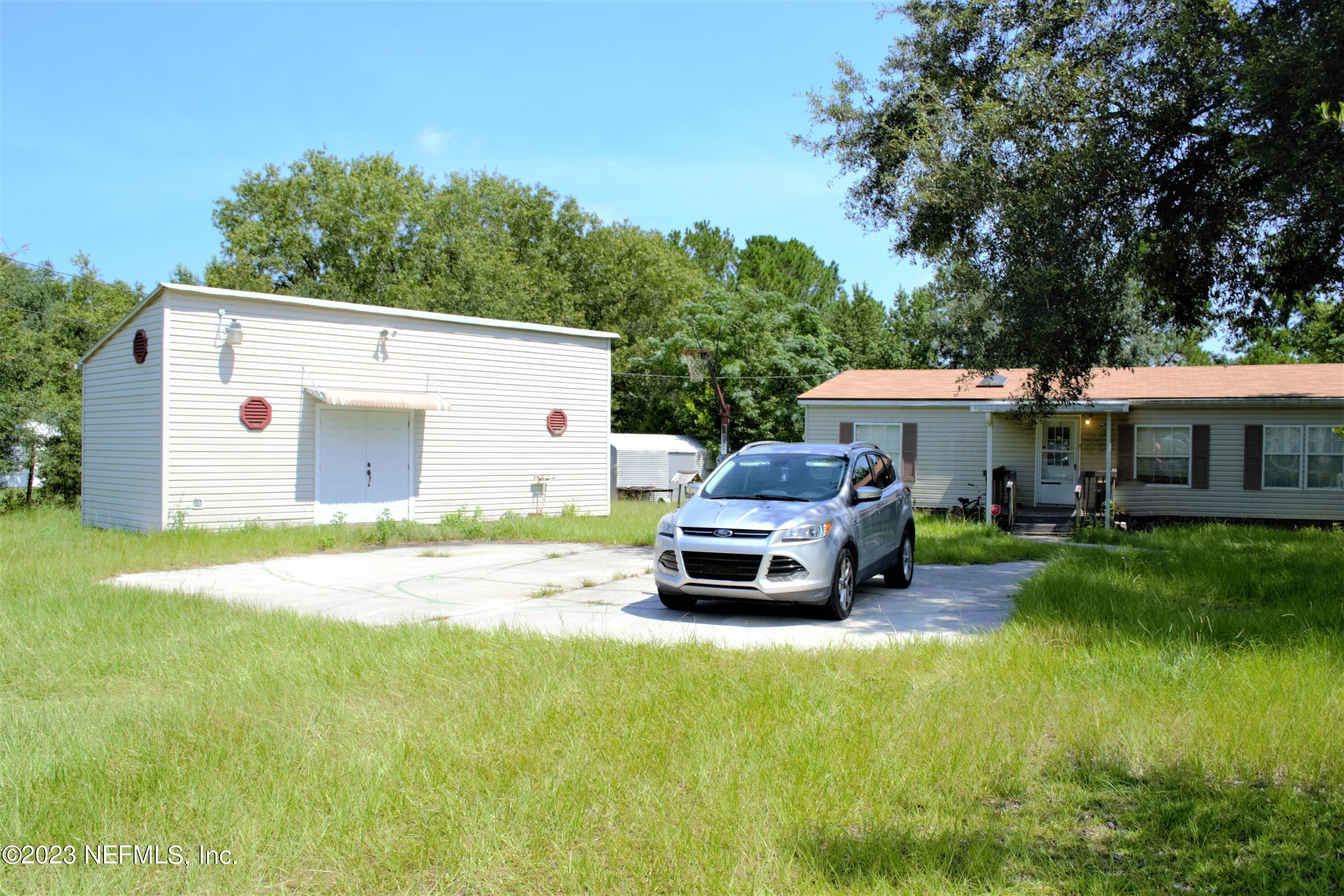 4520 Racoon Run Middleburg, FL 32068 - Photo 25 of 26 a car parked in front of a white house