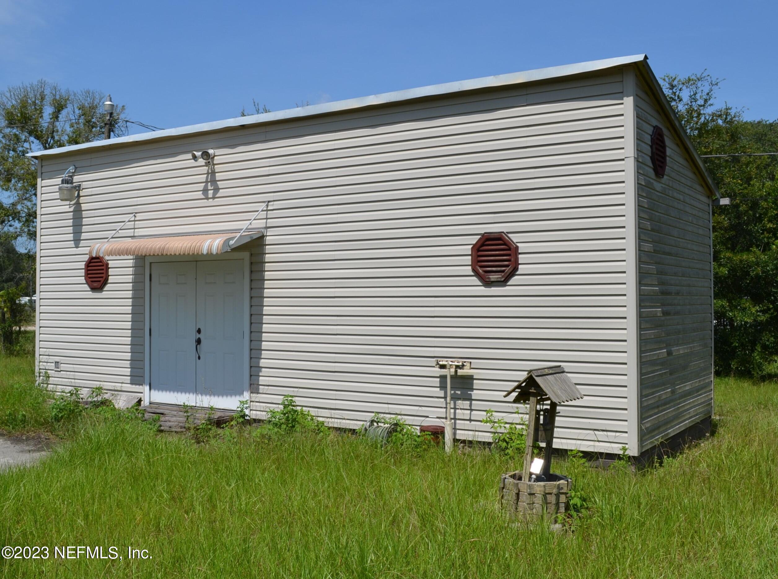 4520 Racoon Run Middleburg, FL 32068 - Photo 3 of 26 a front view of a house with a garden