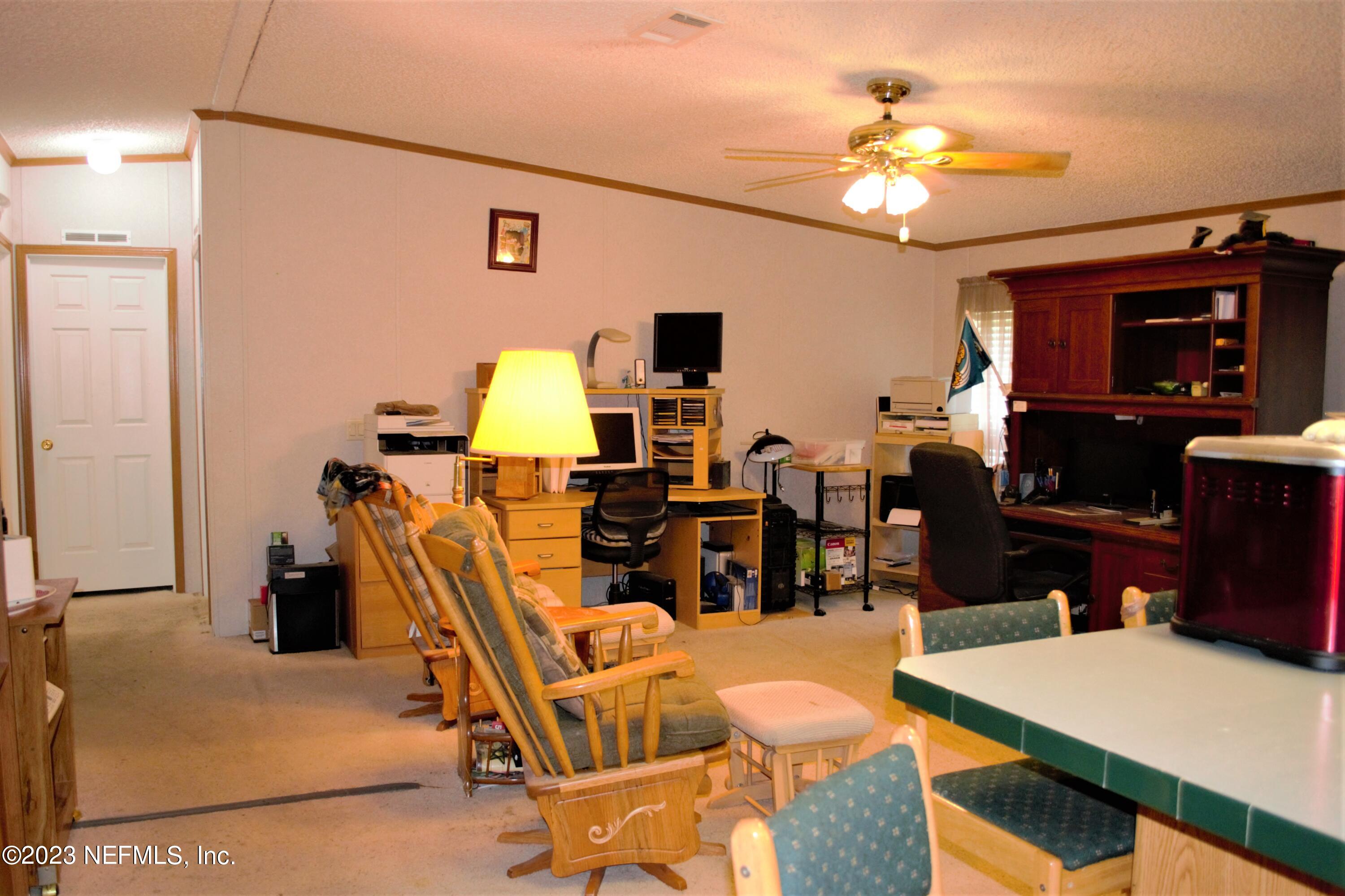 4520 Racoon Run Middleburg, FL 32068 - Photo 6 of 26 a view of a dining room with furniture