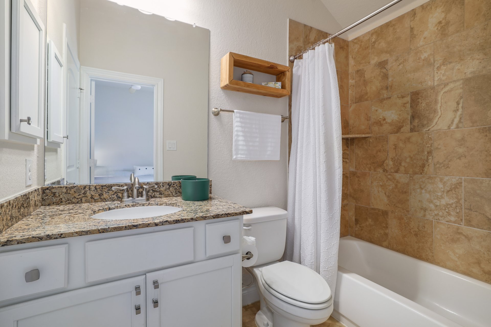 173 Santa Maria Street Georgetown, TX 78628 - Photo 27 of 39 Bathroom featuring a vanity with a stone countertop, and white cabinetry