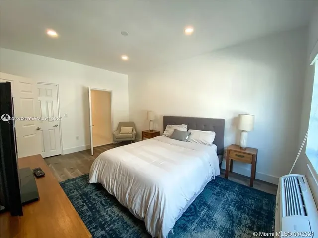 a bedroom with a bed and a mirror