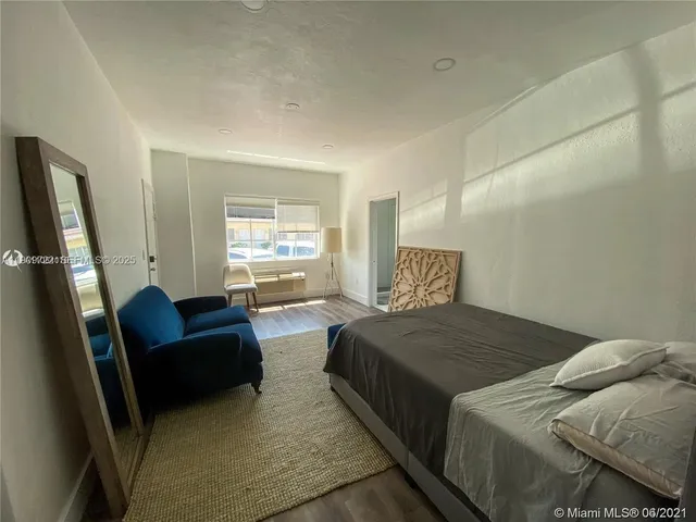 a bedroom with two beds and a couch