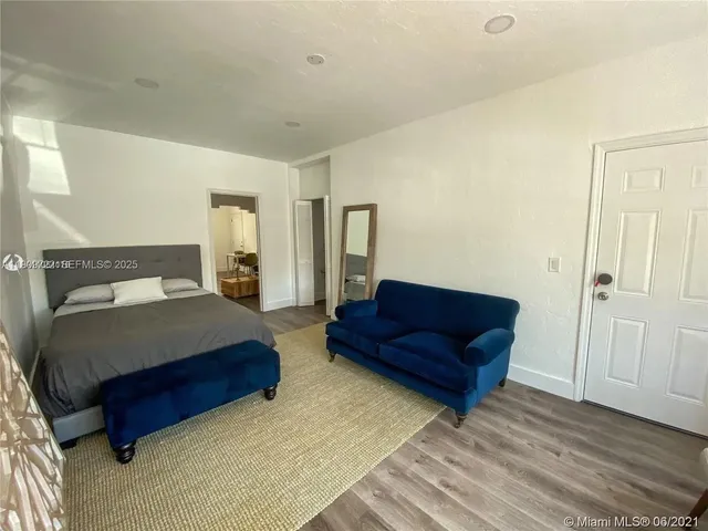 a spacious bedroom with a bed and a couch