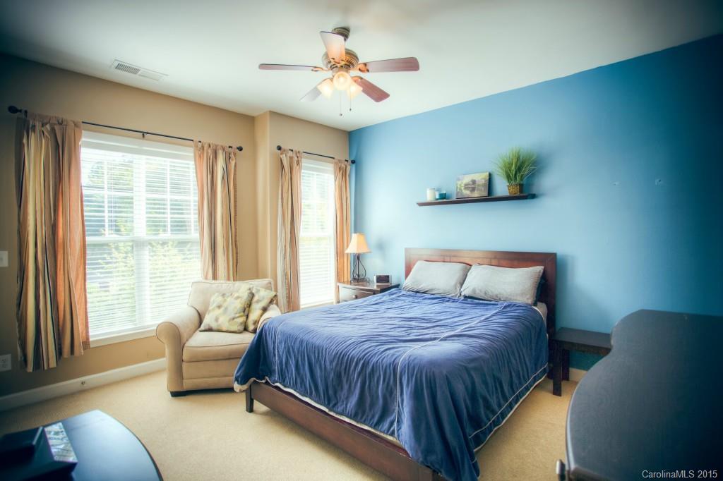 4138 Walker Road, Unit 4138 Charlotte, NC 28211 - Photo 16 of 24 a spacious bedroom with a bed and a chandelier
