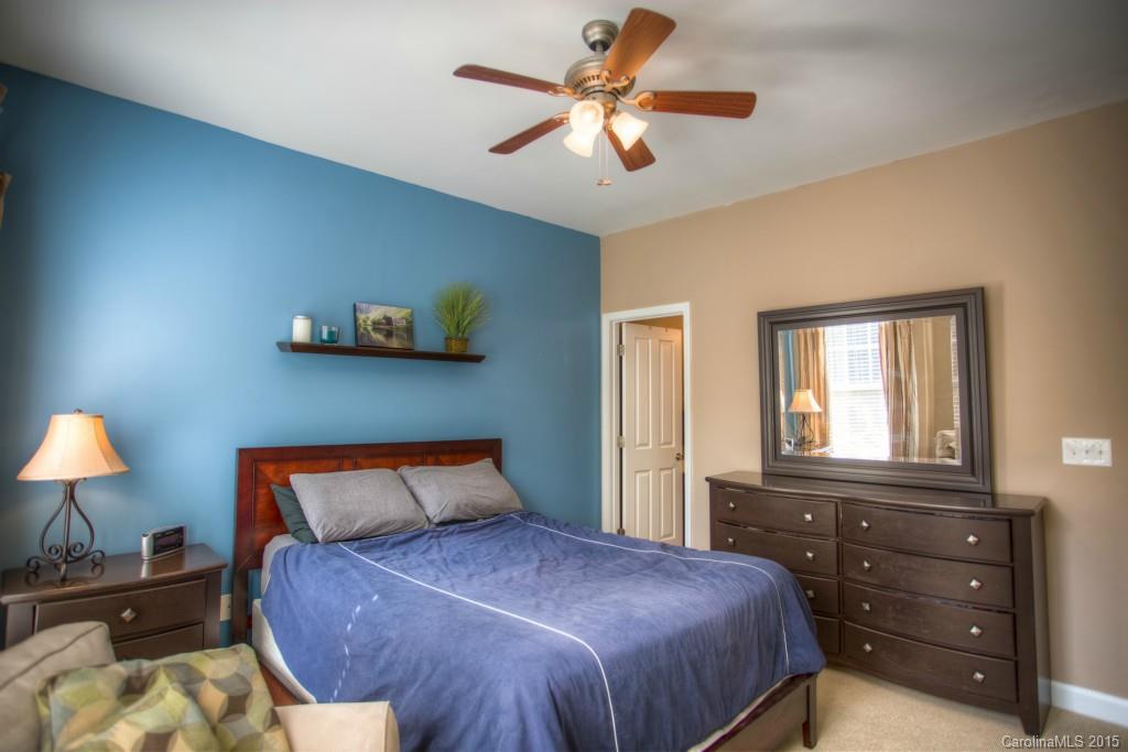 4138 Walker Road, Unit 4138 Charlotte, NC 28211 - Photo 17 of 24 a bedroom with a bed and a chandelier