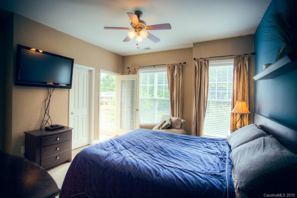 4138 Walker Road, Unit 4138 Charlotte, NC 28211 - Photo 18 of 24 a bedroom with a bed and a flat screen tv