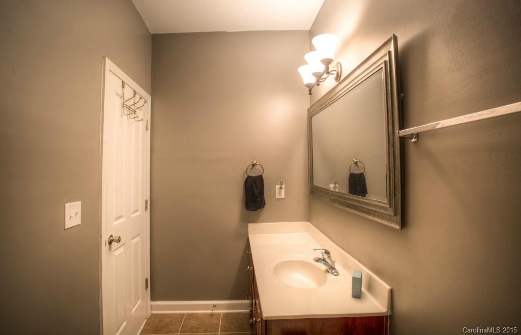 4138 Walker Road, Unit 4138 Charlotte, NC 28211 - Photo 19 of 24 a bathroom with a sink a mirror and vanity