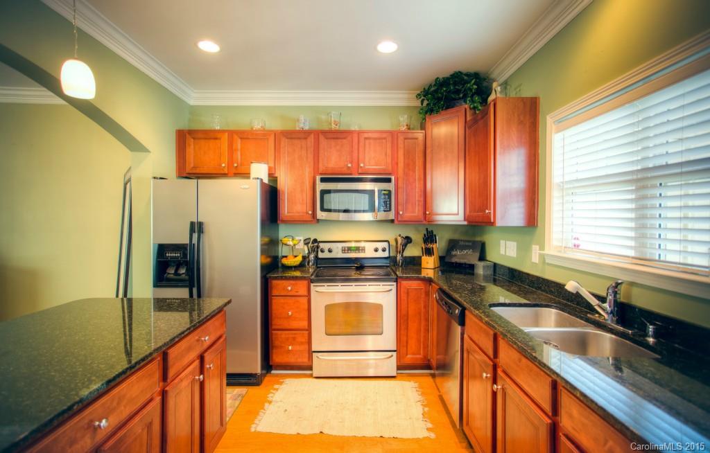 4138 Walker Road, Unit 4138 Charlotte, NC 28211 - Photo 3 of 24 a kitchen with stainless steel appliances granite countertop a refrigerator a stove and a sink