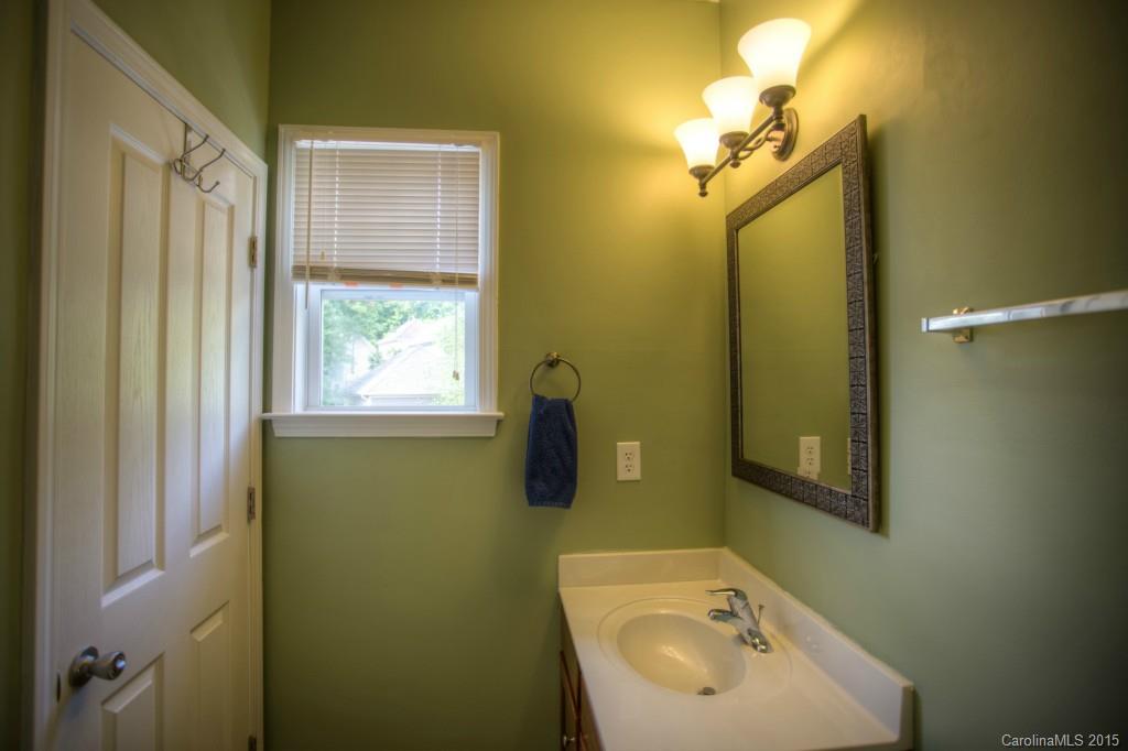 4138 Walker Road, Unit 4138 Charlotte, NC 28211 - Photo 22 of 24 a bathroom with a sink a toilet and mirror