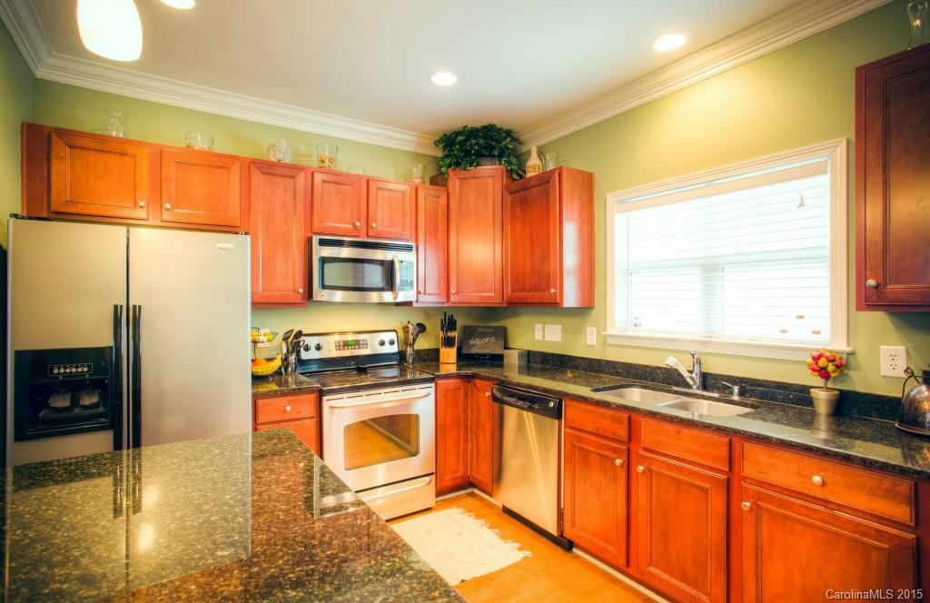 4138 Walker Road, Unit 4138 Charlotte, NC 28211 - Photo 4 of 24 a kitchen with stainless steel appliances granite countertop a stove a sink and a microwave