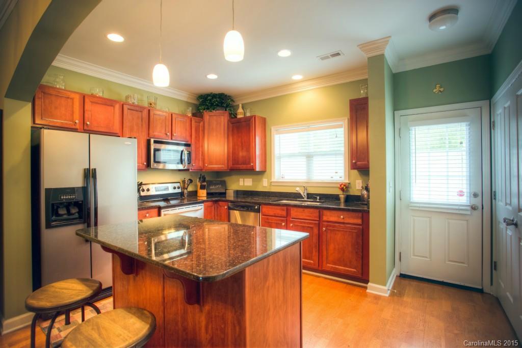 4138 Walker Road, Unit 4138 Charlotte, NC 28211 - Photo 5 of 24 a kitchen with stainless steel appliances granite countertop a sink a stove and a refrigerator