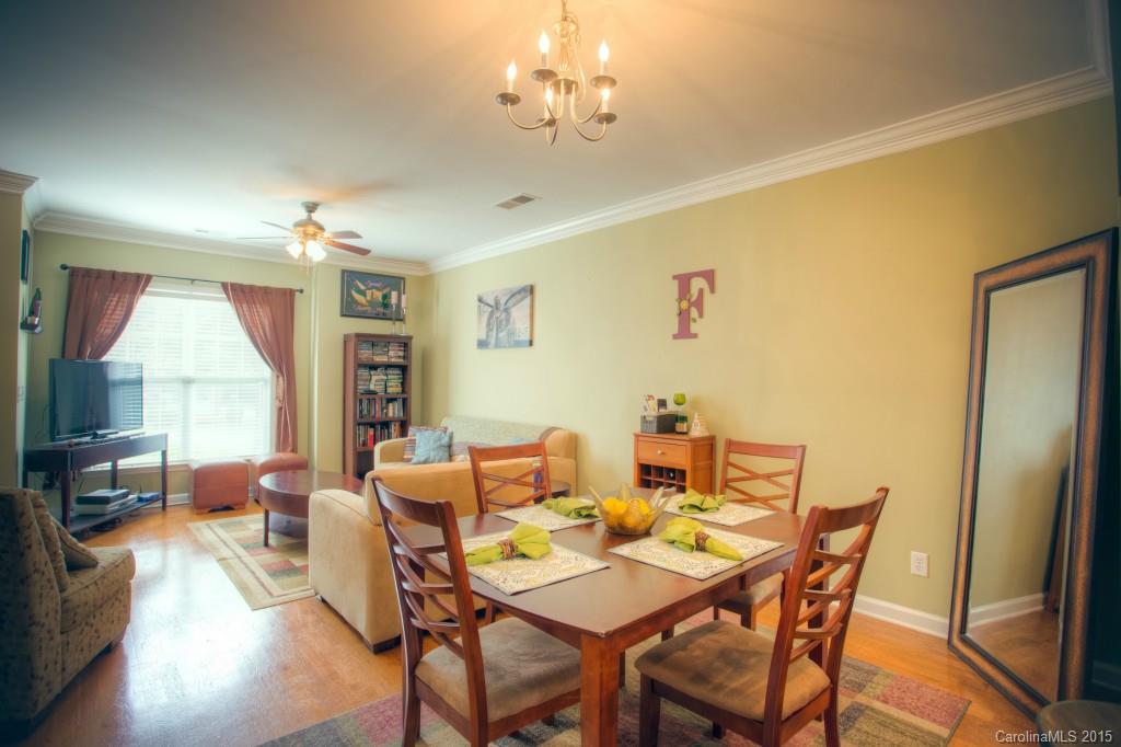4138 Walker Road, Unit 4138 Charlotte, NC 28211 - Photo 7 of 24 a view of a dining room with furniture window and wooden floor