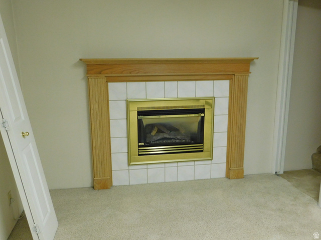 2148 Carolyn Way Bountiful, UT 84010 - Photo 19 of 40 Built-in fireplace featuring a brass surround, white tile hearth, and a wood mantel
