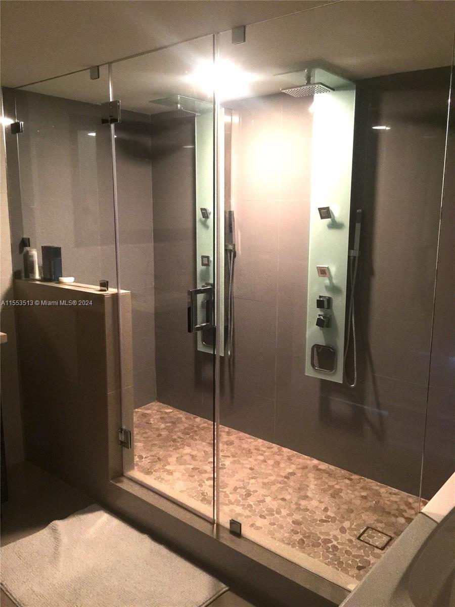 a bathroom with a shower and a sink
