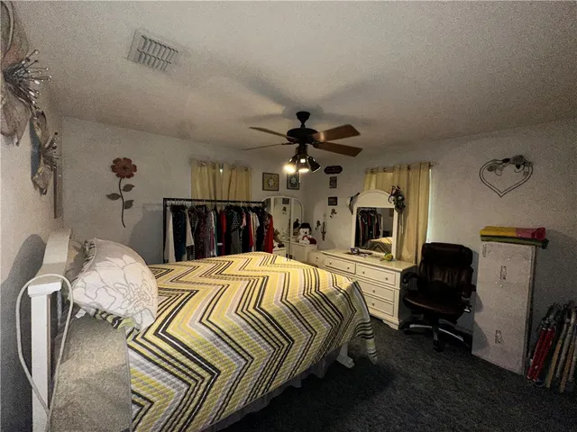 a bedroom with a bed and a mirror