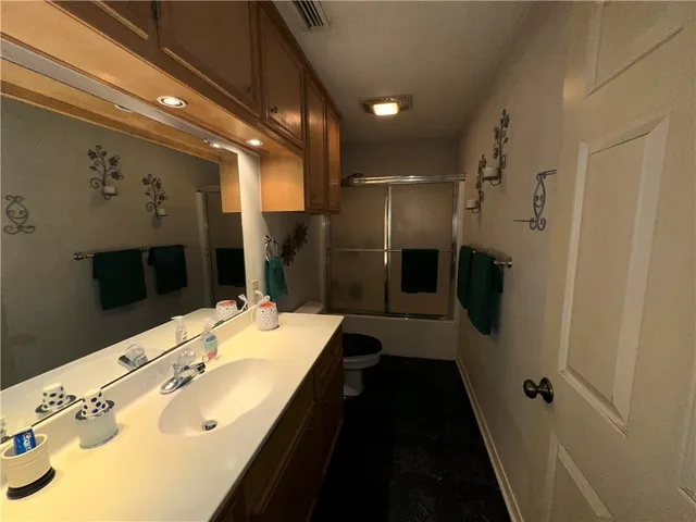 a bathroom with a double vanity sink a large mirror and shower