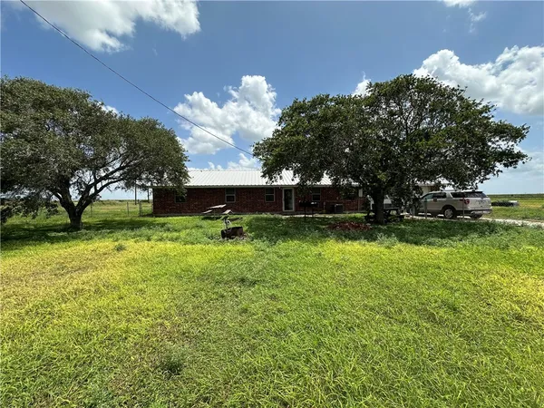 a view of yard with grass & wall