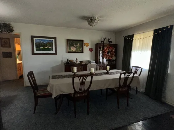a view of a dining room with furniture and window