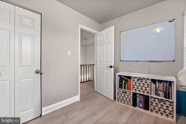 a living room with furniture and a book shelf
