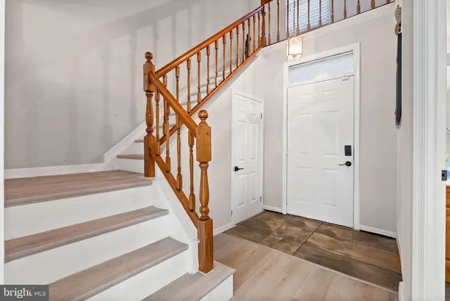 a view of staircase with wooden floor and a rug