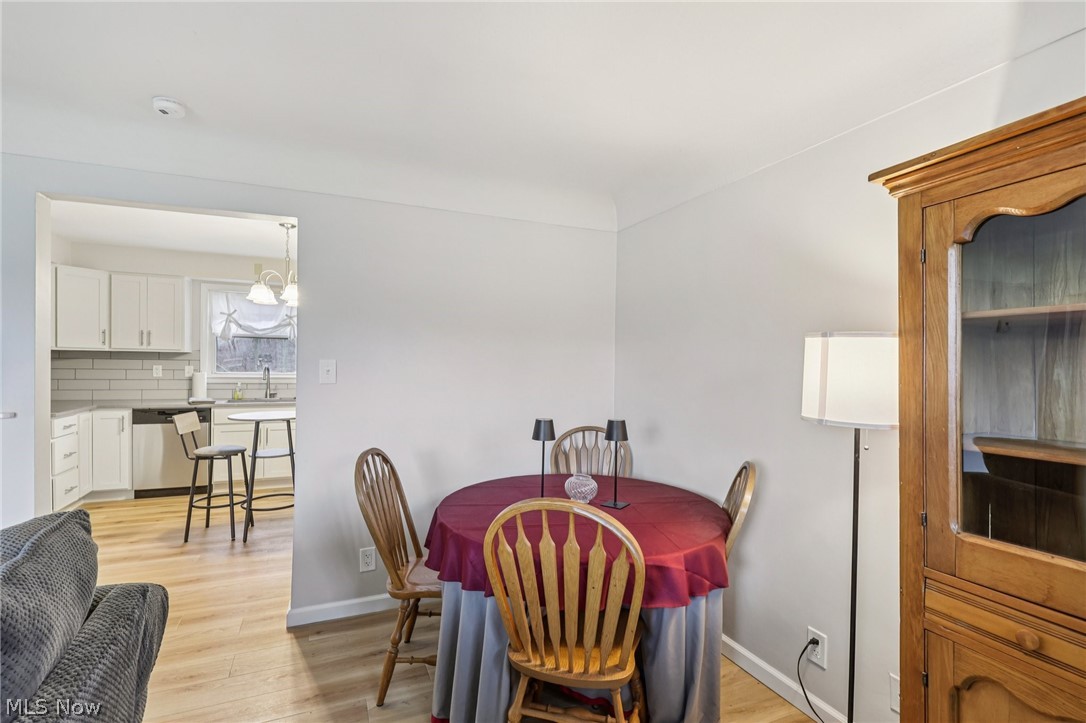 34825 Aurora Road Solon, OH 44139 - Photo 5 of 13 Dining space featuring light wood-style flooring and suspended lighting