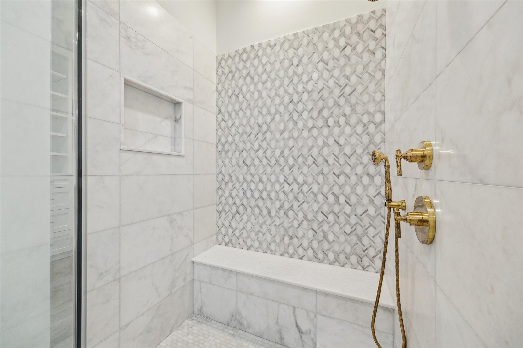25 Wentworth Gate Path Houston, TX 77027 - Photo 18 of 32 Framed glass shower with mosaic floor, large niche, and bench create a cohesive space.